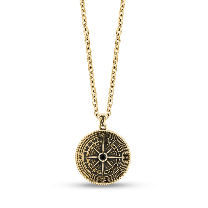 Pendentif boussole détaillée en pierre noire